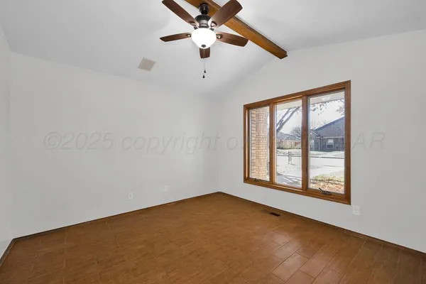 a view of an empty room with a window