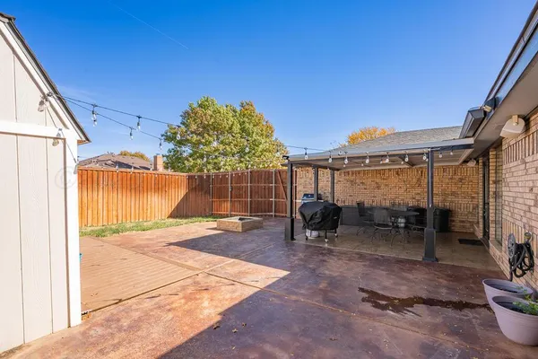 a view of a backyard with a patio