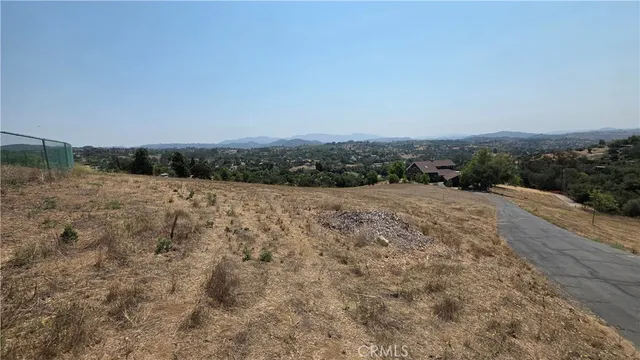 a view of dirt road with a building in the background