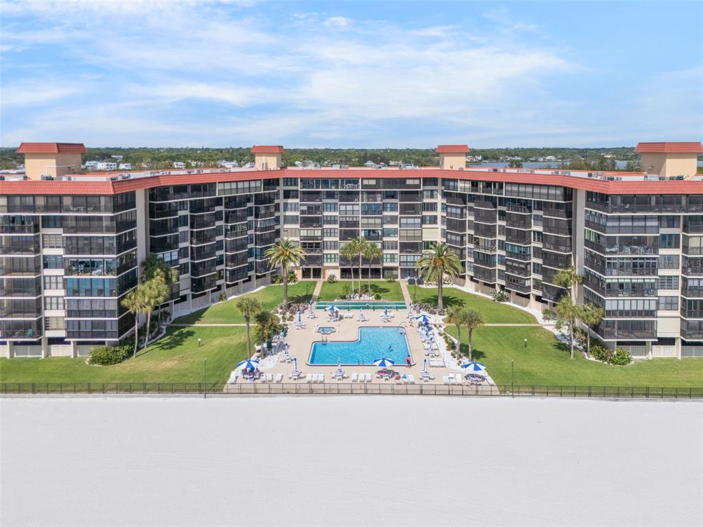 18304 Gulf Boulevard, Unit 105 Redington Shores, FL 33708 - Photo 1 of 33 a picture of a building with a garden and trees