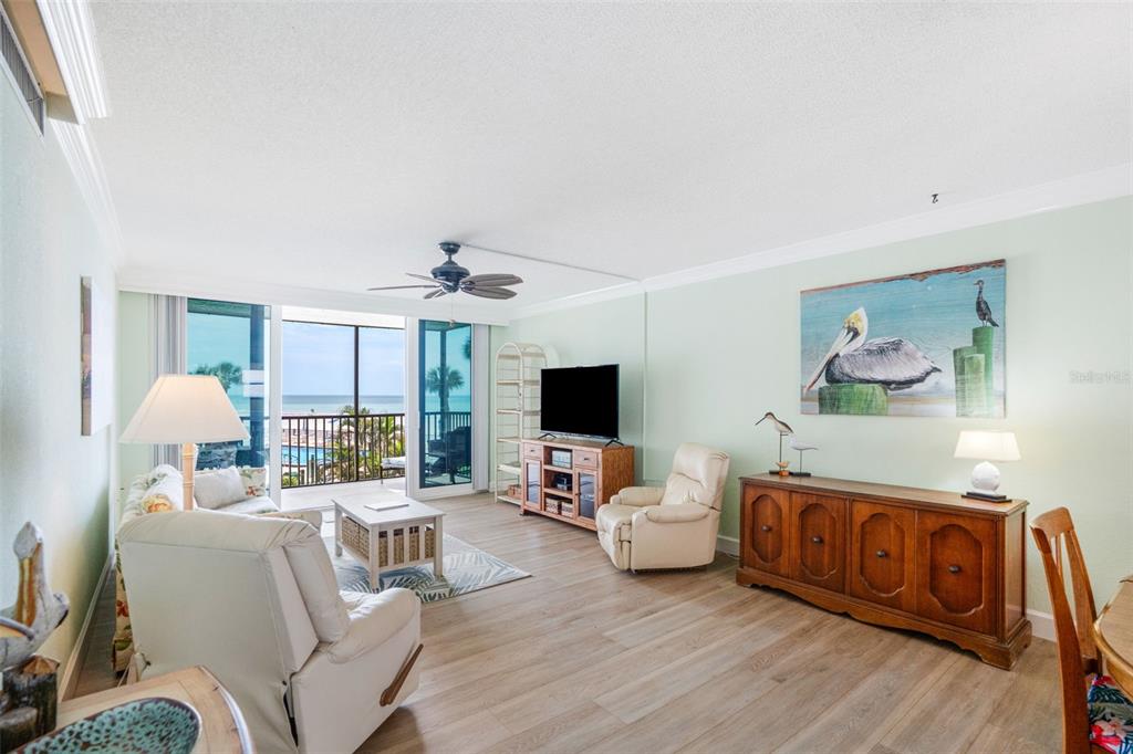 18304 Gulf Boulevard, Unit 105 Redington Shores, FL 33708 - Photo 11 of 33 a living room with furniture and a flat screen tv