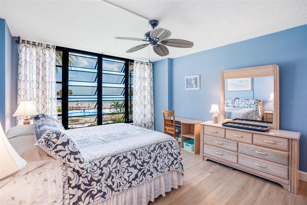 18304 Gulf Boulevard, Unit 105 Redington Shores, FL 33708 - Photo 17 of 33 a bedroom with a bed and a dresser