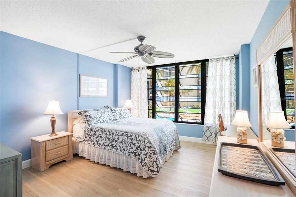 18304 Gulf Boulevard, Unit 105 Redington Shores, FL 33708 - Photo 18 of 33 a bedroom with a bed and a chandelier