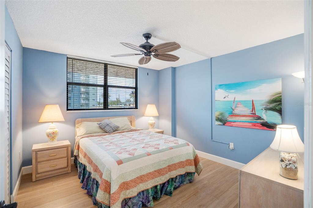 18304 Gulf Boulevard, Unit 105 Redington Shores, FL 33708 - Photo 21 of 33 a bedroom with a bed and a chandelier