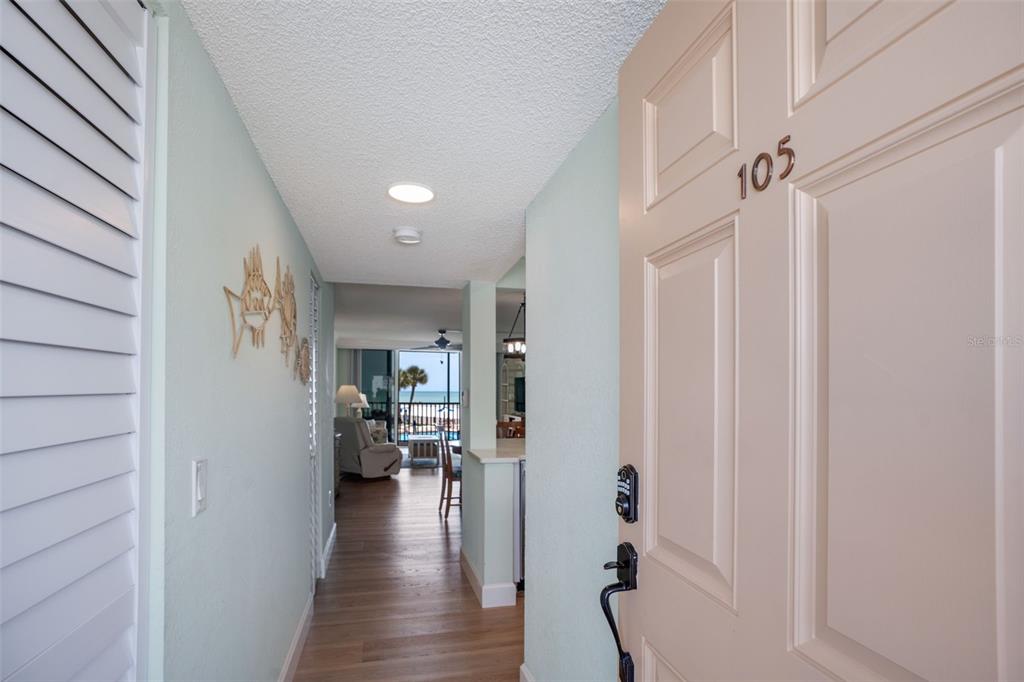 18304 Gulf Boulevard, Unit 105 Redington Shores, FL 33708 - Photo 3 of 33 a view of a hallway view with wooden floor and staircase
