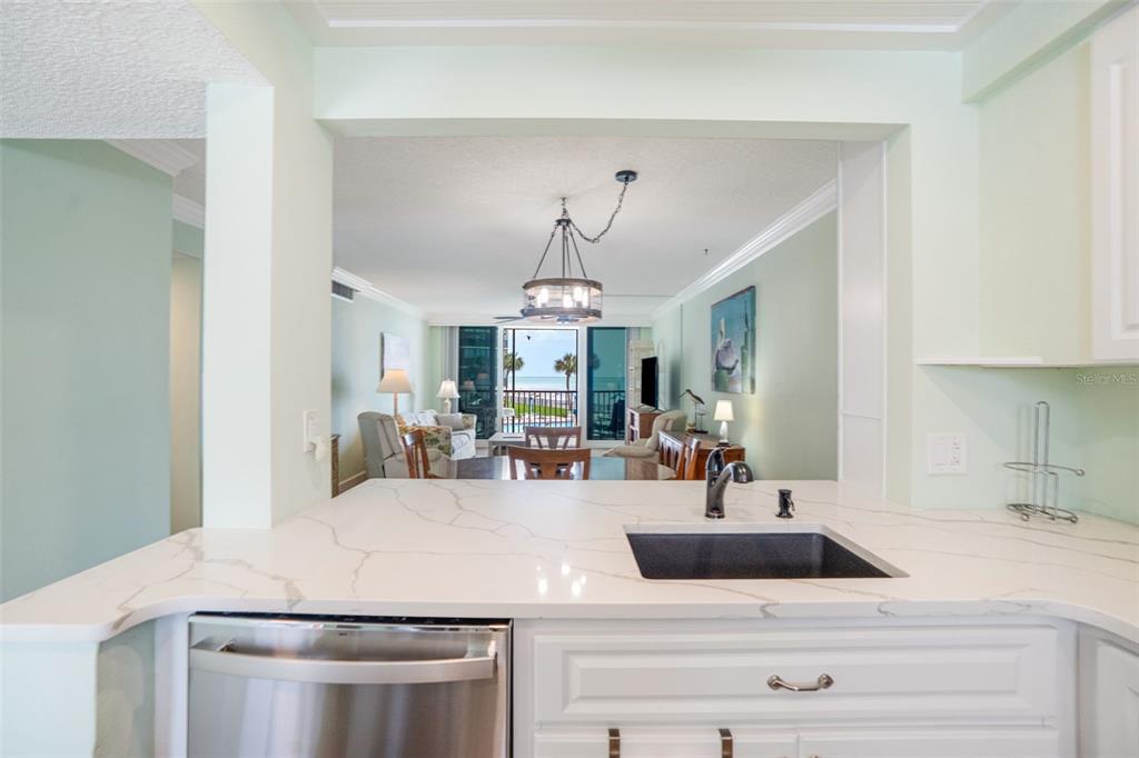 18304 Gulf Boulevard, Unit 105 Redington Shores, FL 33708 - Photo 8 of 33 a kitchen with a sink and a refrigerator