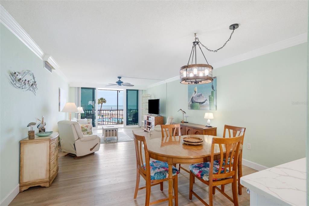 18304 Gulf Boulevard, Unit 105 Redington Shores, FL 33708 - Photo 10 of 33 a view of a dining room with furniture wooden floor and a chandelier
