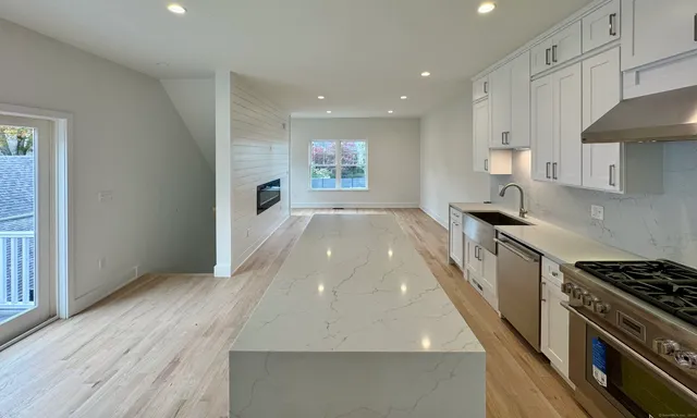 a kitchen with granite countertop a stove and a refrigerator