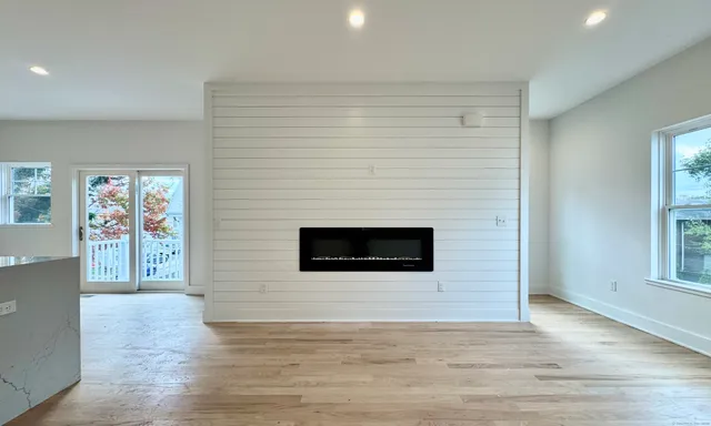 a view of a livingroom with an empty space and a fireplace