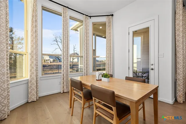 a view of a dining room with furniture and window