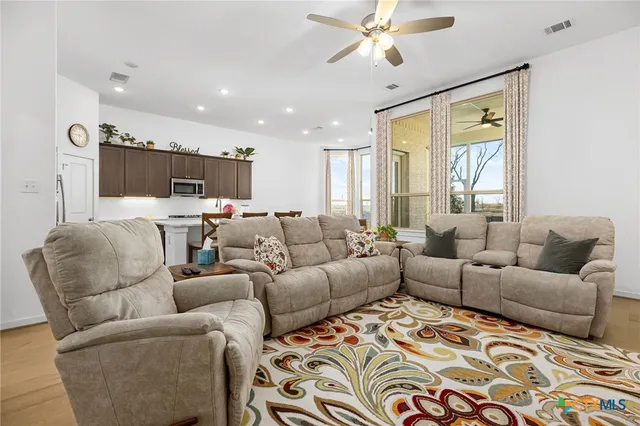 a living room with furniture and a large window