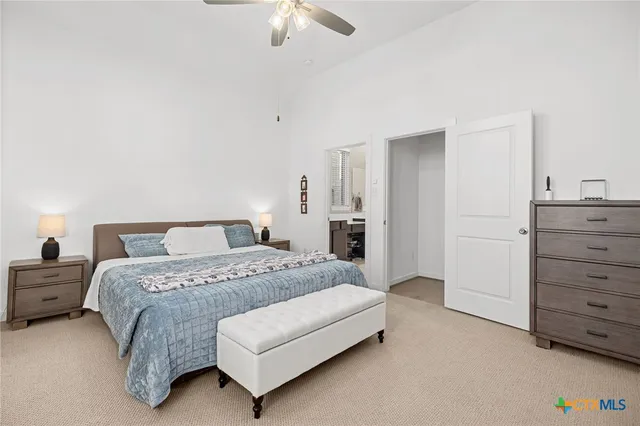 a spacious bedroom with a bed and a dresser