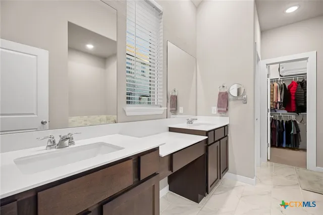 a bathroom with a sink double vanity and a mirror
