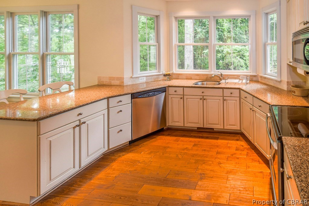 137 Mastons Wharf Road Lancaster, VA 22503 - Photo 12 of 39 a large kitchen with granite countertop a sink and a window