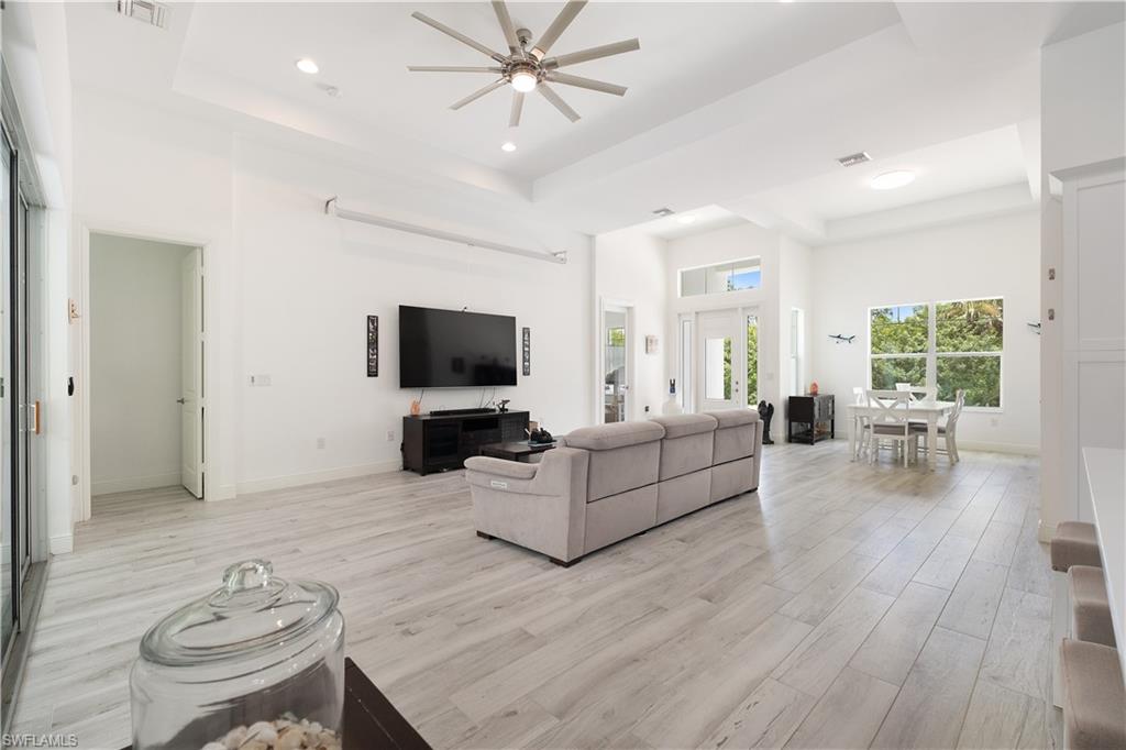 693 7th Street Northwest Naples, FL 34120 - Photo 11 of 32 a living room with furniture and a flat screen tv