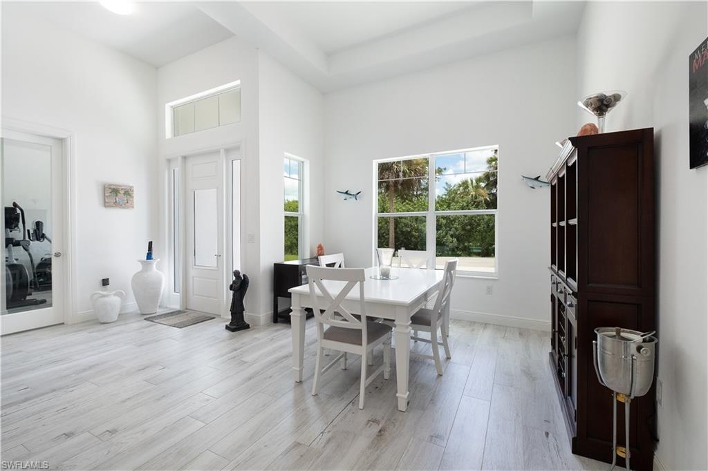 693 7th Street Northwest Naples, FL 34120 - Photo 15 of 32 a view of a dining room with furniture and wooden floor
