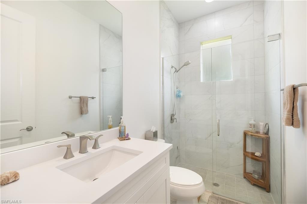693 7th Street Northwest Naples, FL 34120 - Photo 19 of 32 a bathroom with a sink a toilet and shower