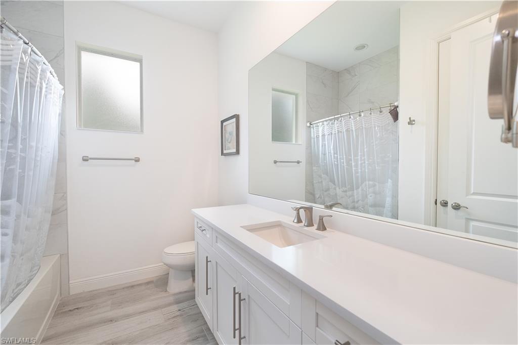 693 7th Street Northwest Naples, FL 34120 - Photo 21 of 32 a bathroom with a sink a toilet and shower
