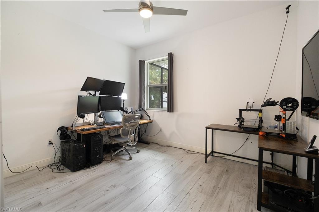 693 7th Street Northwest Naples, FL 34120 - Photo 22 of 32 a view of a workspace with furniture and wooden floor