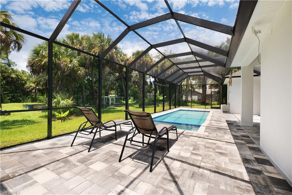 693 7th Street Northwest Naples, FL 34120 - Photo 24 of 32 a view of swimming pool with a patio and a yard