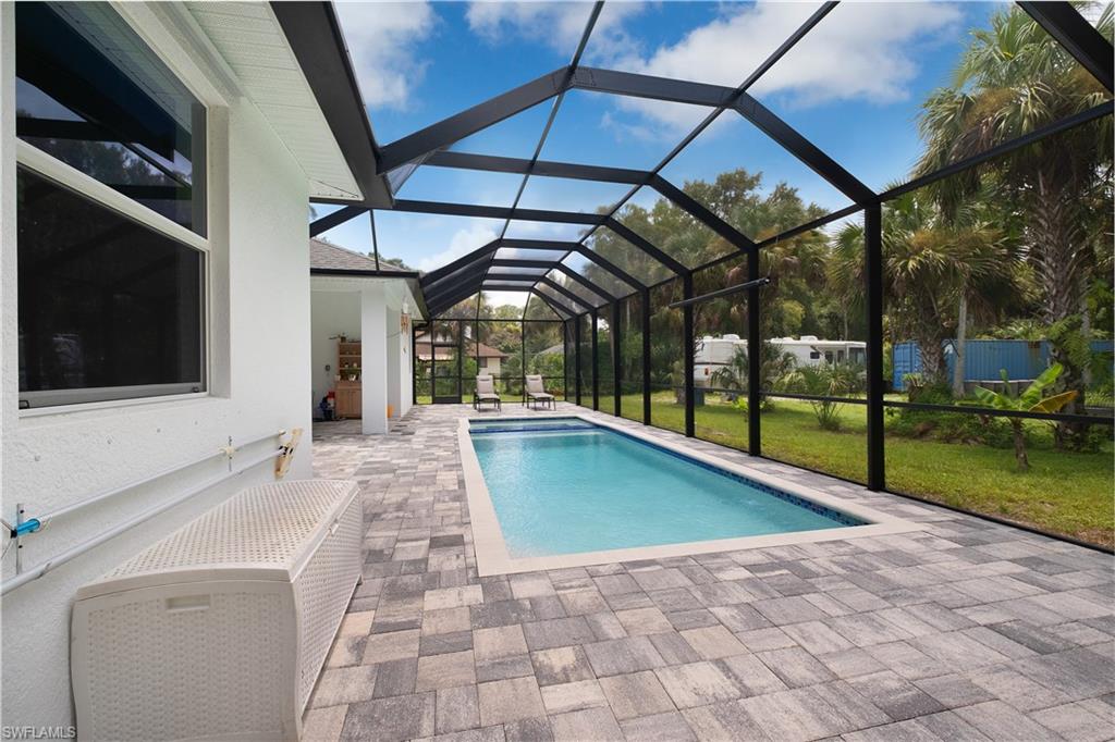693 7th Street Northwest Naples, FL 34120 - Photo 25 of 32 a view of swimming pool with a bench in patio