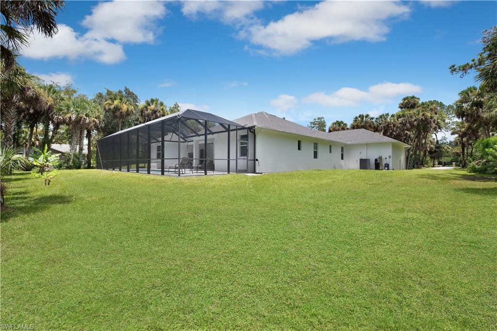 693 7th Street Northwest Naples, FL 34120 - Photo 27 of 32 a view of a house with a big yard