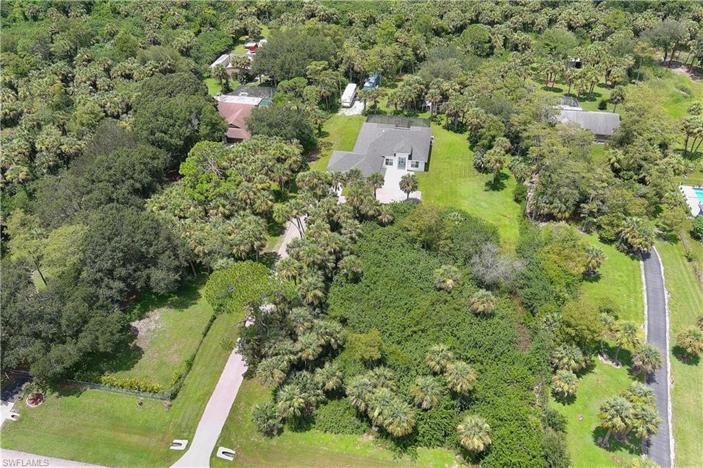 693 7th Street Northwest Naples, FL 34120 - Photo 30 of 32 an aerial view of residential house with outdoor space and trees all around
