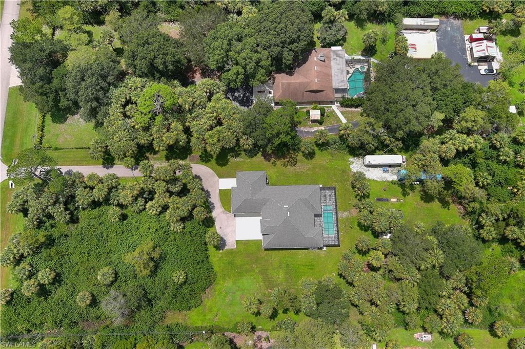 693 7th Street Northwest Naples, FL 34120 - Photo 3 of 32 an aerial view of a house with a yard