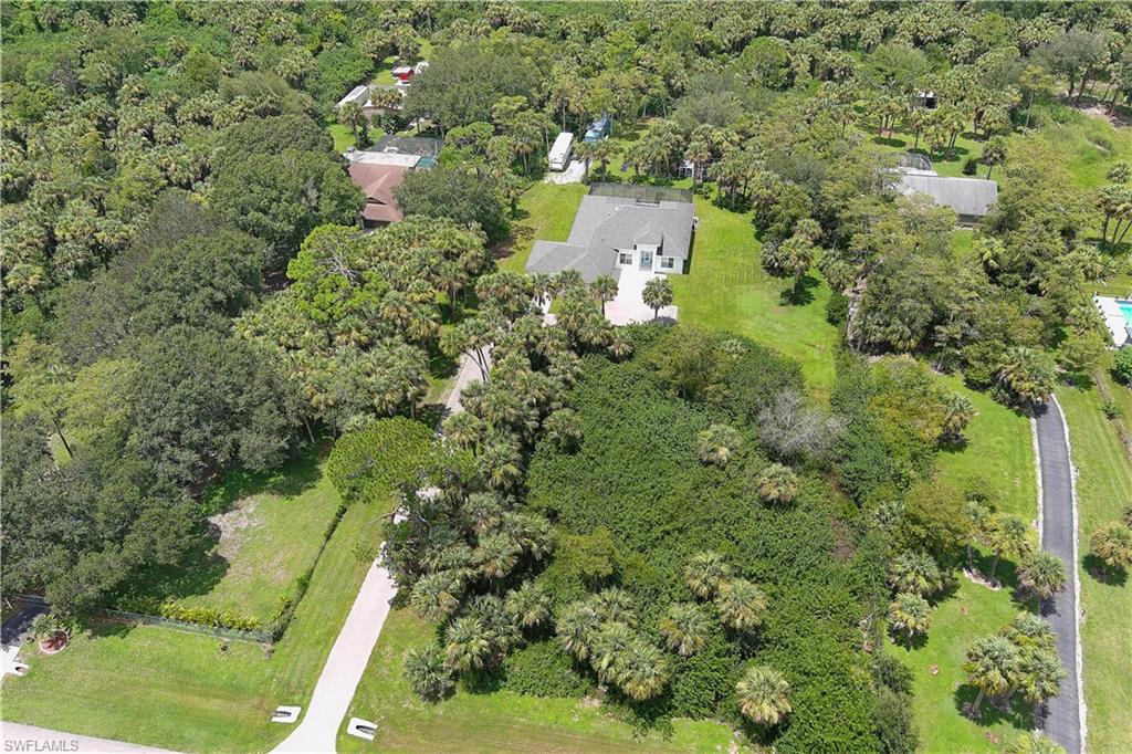 693 7th Street Northwest Naples, FL 34120 - Photo 31 of 32 an aerial view of residential house with outdoor space and trees all around