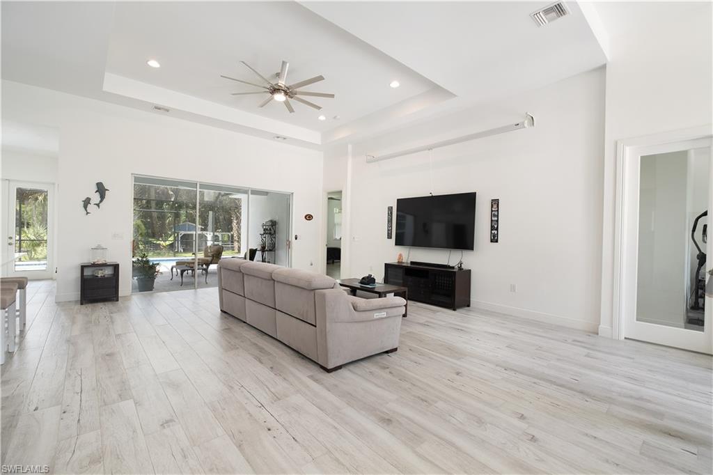 693 7th Street Northwest Naples, FL 34120 - Photo 6 of 32 a living room with furniture and a flat screen tv
