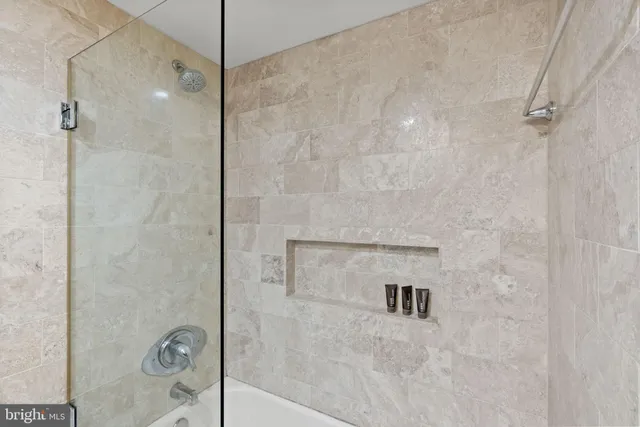 a view of a hallway with wooden floor and closet
