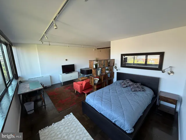 a bedroom with two beds and a flat screen tv