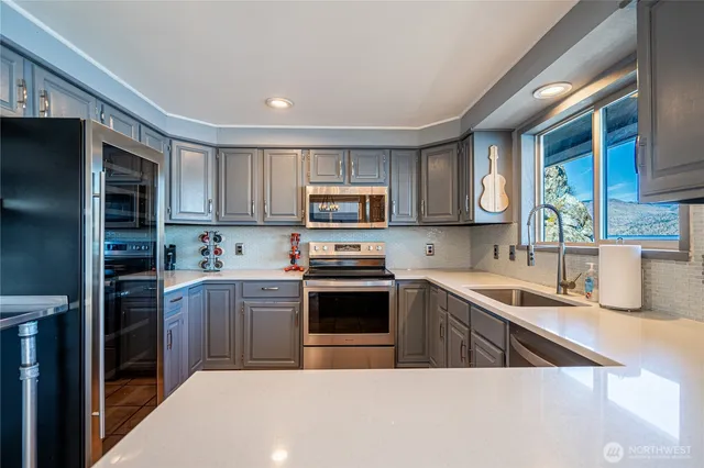 a bathroom with a granite countertop toilet sink and mirror