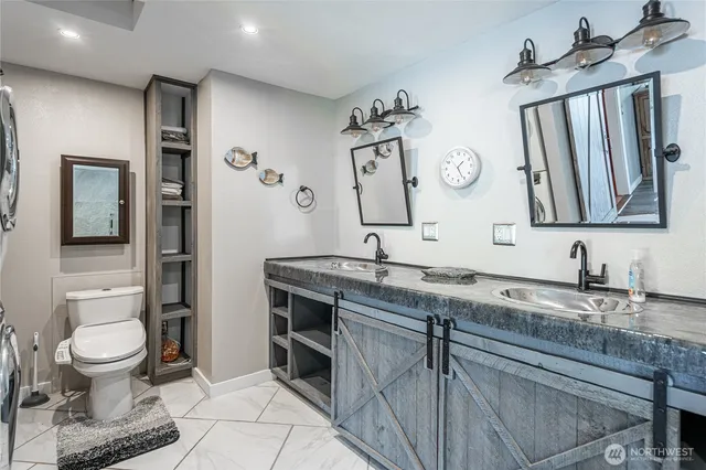 a bathroom with a granite countertop sink a mirror and shower