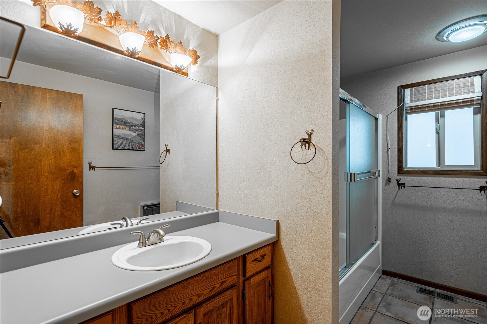 10370 South Lakeshore Road Chelan, WA 98816 - Photo 29 of 31 a bathroom with a granite countertop sink a mirror and shower