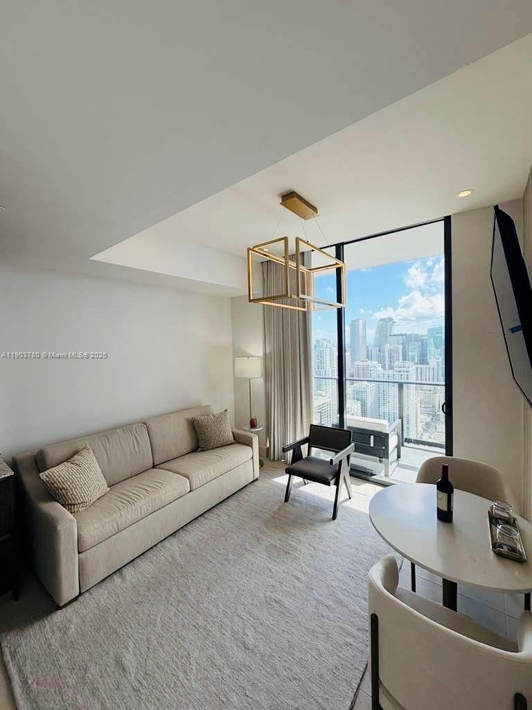 159 Northeast 6th Street, Unit PH5014 Miami, FL 33132 - Photo 11 of 41 a living room with furniture and large windows