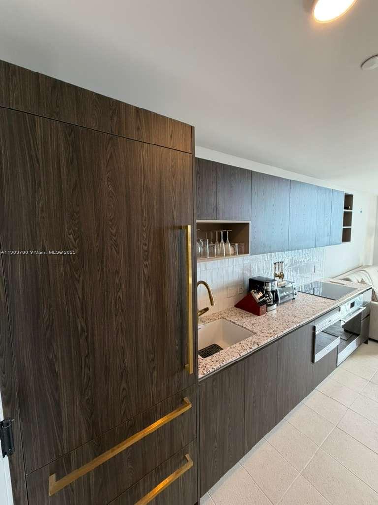 159 Northeast 6th Street, Unit PH5014 Miami, FL 33132 - Photo 13 of 41 a kitchen with a sink and cabinets