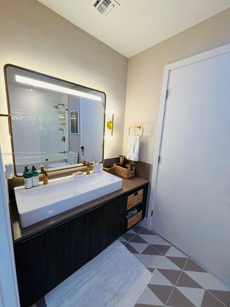 159 Northeast 6th Street, Unit PH5014 Miami, FL 33132 - Photo 22 of 41 a bathroom with a sink and a mirror