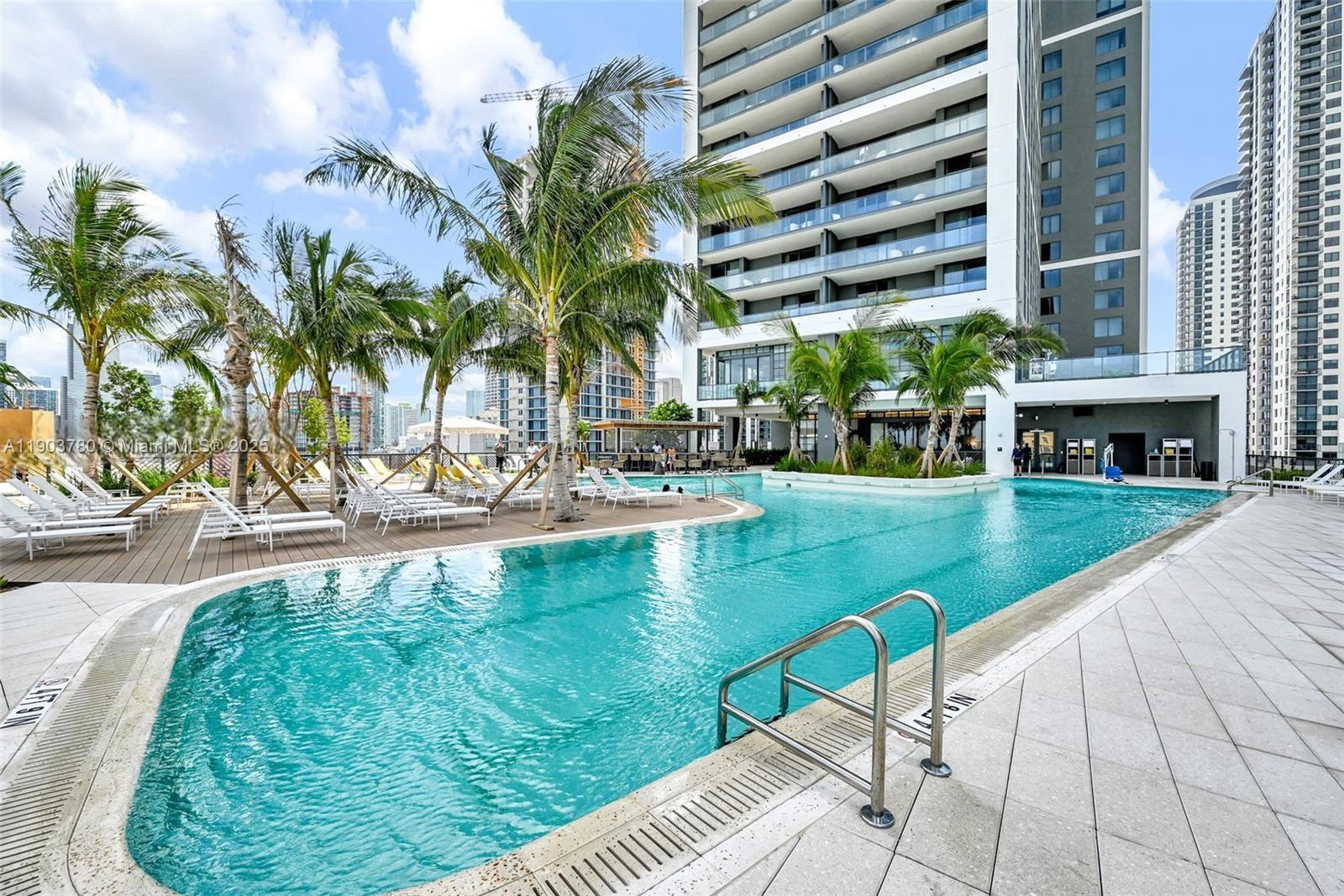 159 Northeast 6th Street, Unit PH5014 Miami, FL 33132 - Photo 34 of 41 a swimming pool with outdoor seating and yard