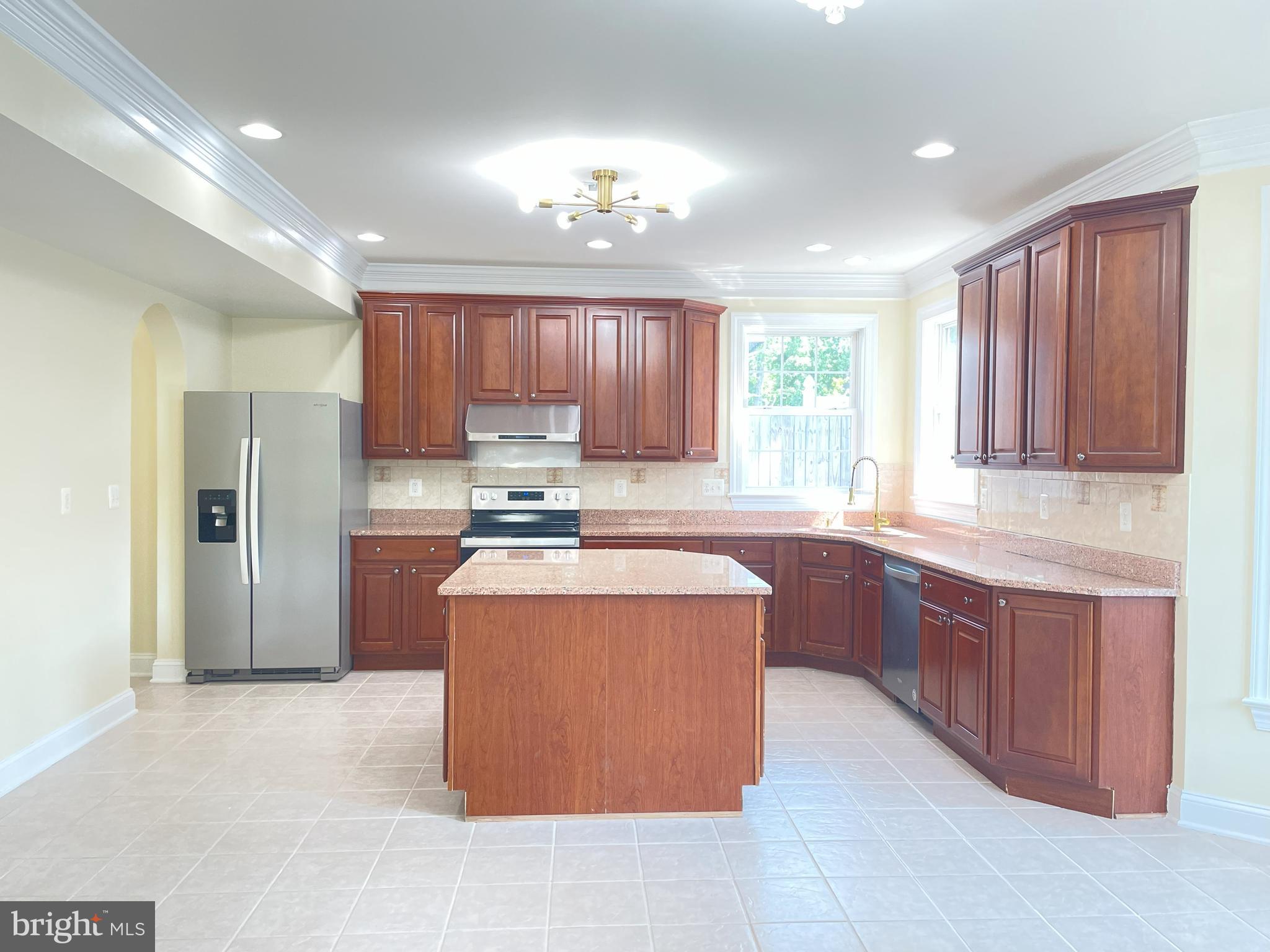 7212 Highland Street Springfield, VA 22150 - Photo 13 of 60 a kitchen with stainless steel appliances granite countertop wooden cabinets a granite counter top and a stove