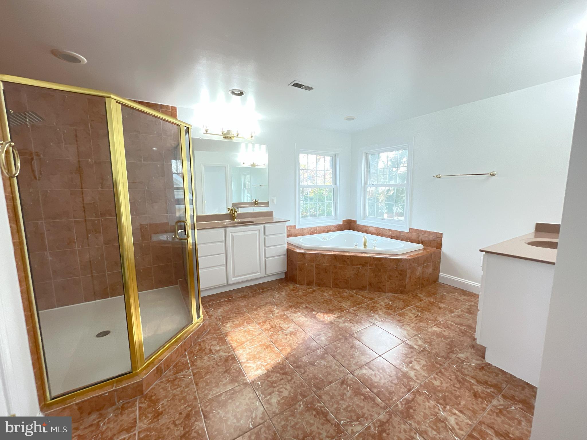 7212 Highland Street Springfield, VA 22150 - Photo 21 of 60 a spacious bathroom with a double vanity sink a mirror and a bathtub