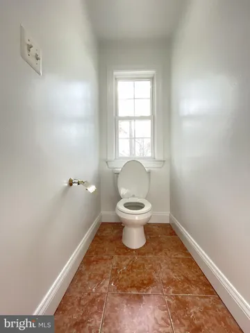 a bathroom with a toilet sink and shower