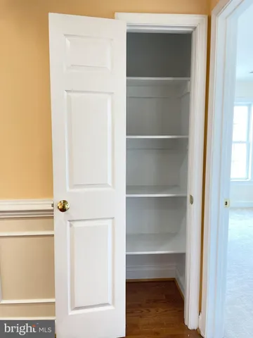 a white toilet sitting next to a bathroom sink and a mirror