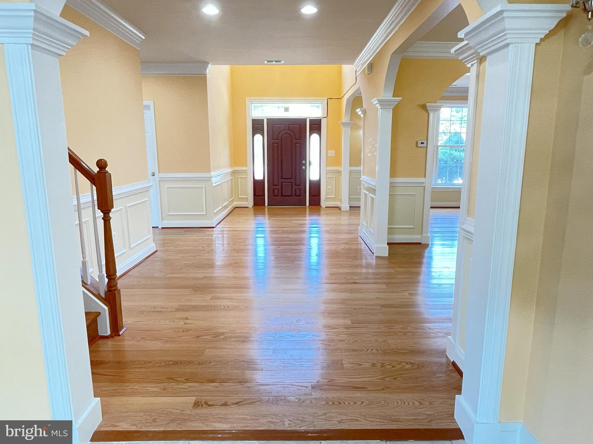 7212 Highland Street Springfield, VA 22150 - Photo 4 of 60 a view of a hallway view with wooden floor and staircase