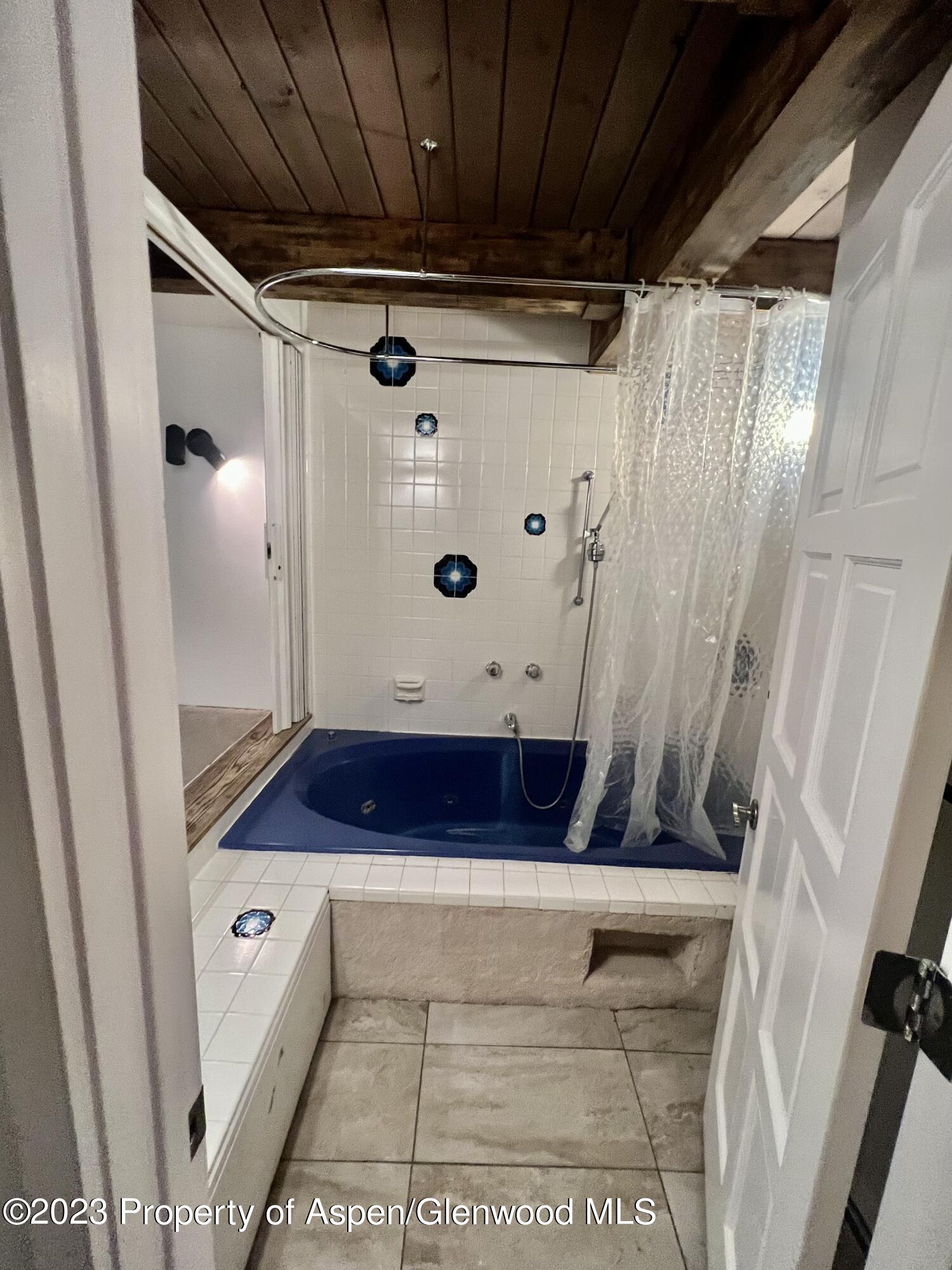 651 South Monarch Street Aspen, CO 81611 - Photo 16 of 19 a bathroom with a tub shower vanity and a sink