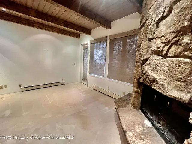 a view of a room with wooden floor and windows
