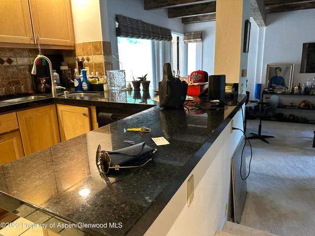 a kitchen with stainless steel appliances granite countertop sink stove and cabinets