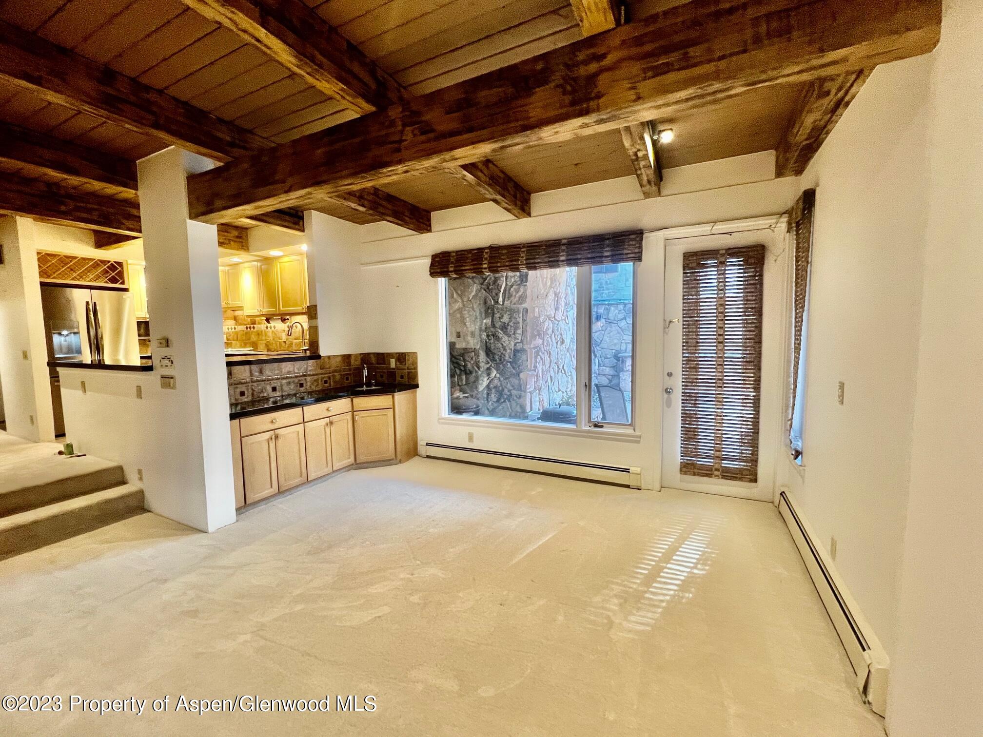 651 South Monarch Street Aspen, CO 81611 - Photo 9 of 19 a view of an empty room with a kitchen