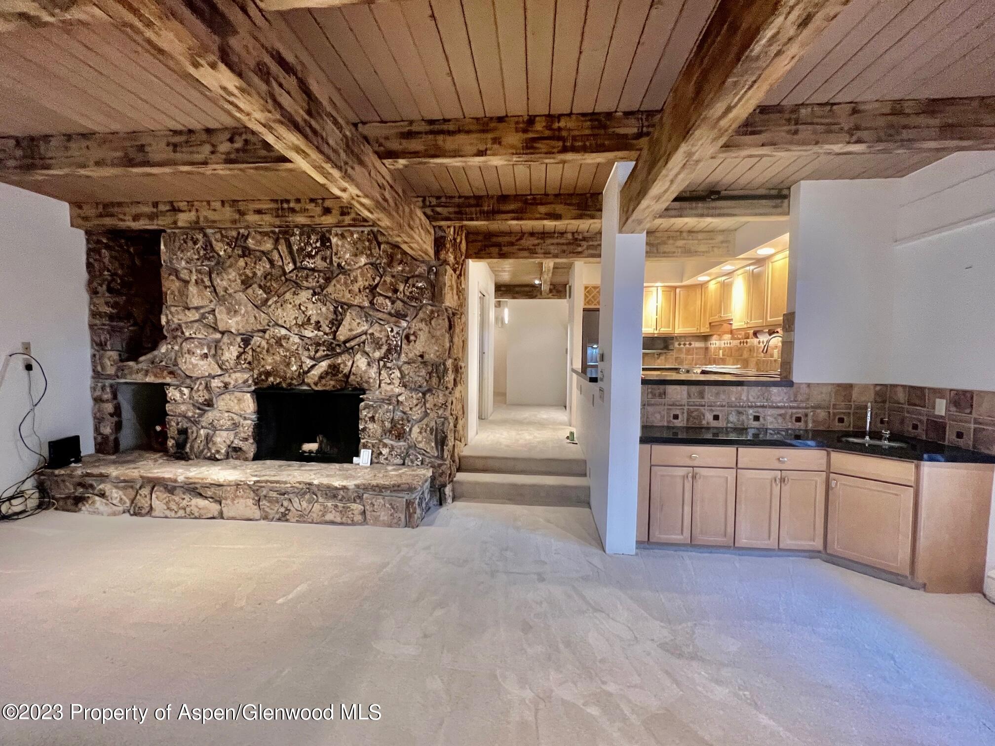 651 South Monarch Street Aspen, CO 81611 - Photo 10 of 19 a large kitchen with a fireplace and a sink