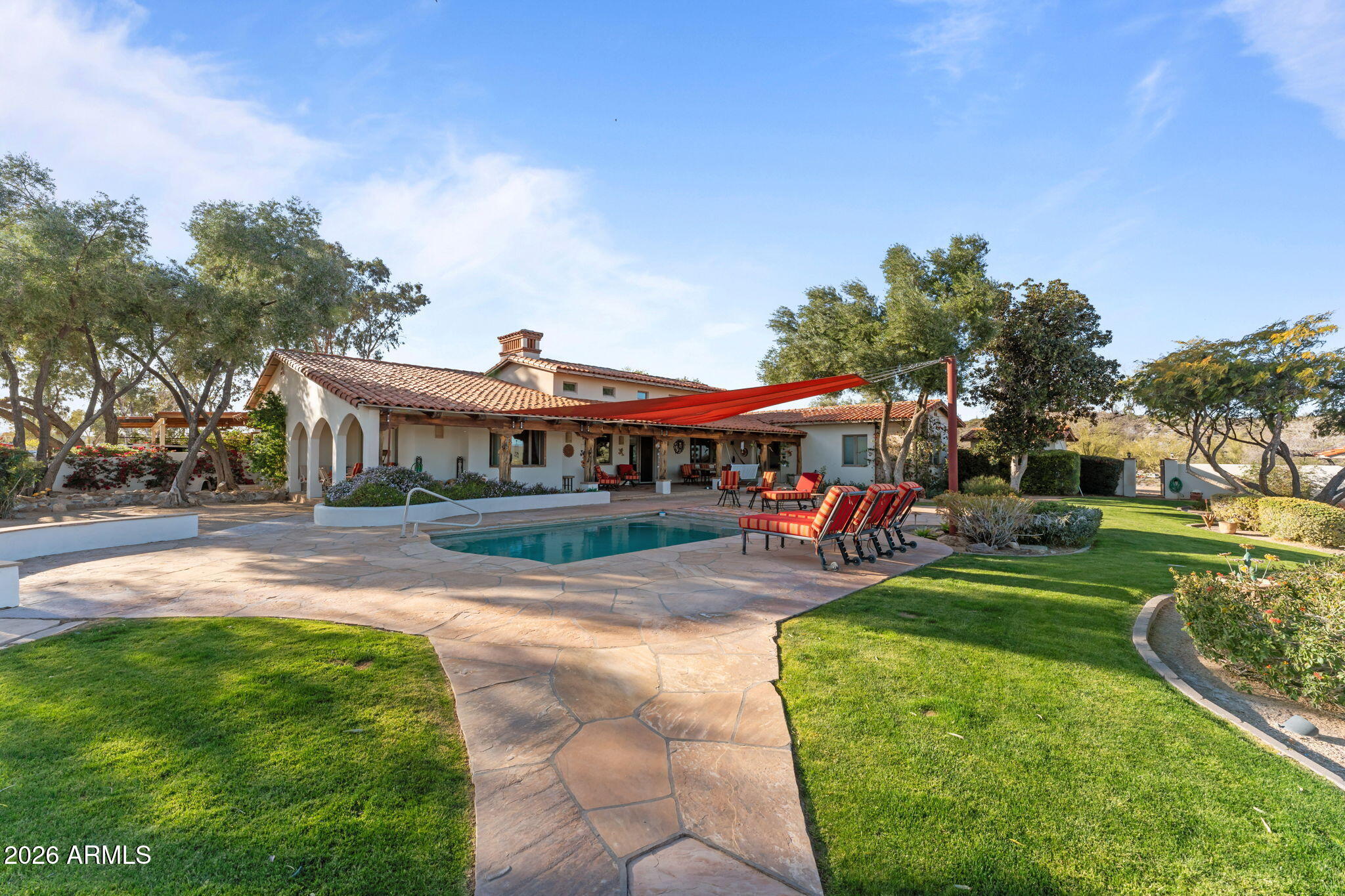 18210 Moonlight Mesa Road Wickenburg, AZ 85390 - Photo 110 of 141 a front view of a house with a yard table and chairs